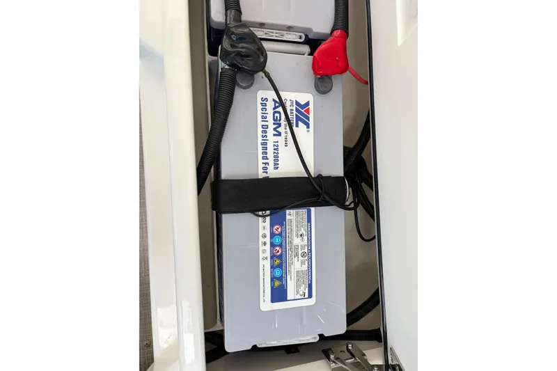 Slide: The Image of Battery compartment of 2025 Aquila 36 Cruiser with secured AGM battery. - 57