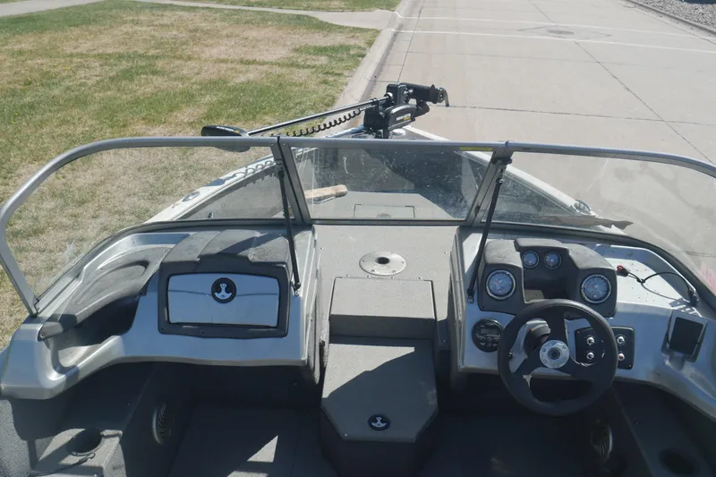Slide: The Image of 2018 Tracker Pro Guide V-165 WT boat interior with steering wheel and dashboard. - 4