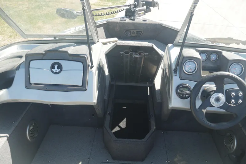 Slide: The Image of 2018 Tracker Pro Guide V-165 WT boat interior with steering wheel and dashboard controls. - 5