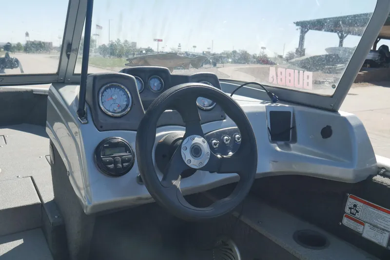 Slide: The Image of 2018 Tracker Pro Guide V-165 WT boat dashboard with steering wheel and gauges. - 6