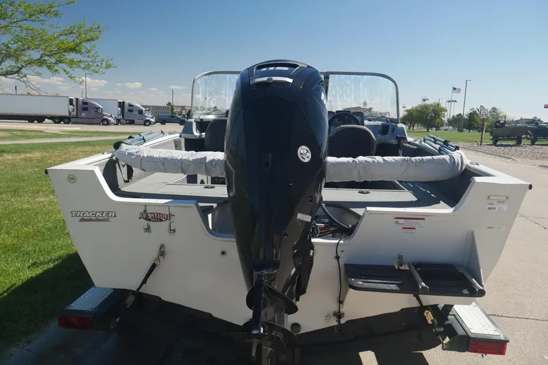 Slide: The Image of 2018 Tracker Pro Guide V-165 WT boat with outboard motor, parked on a trailer. - 8