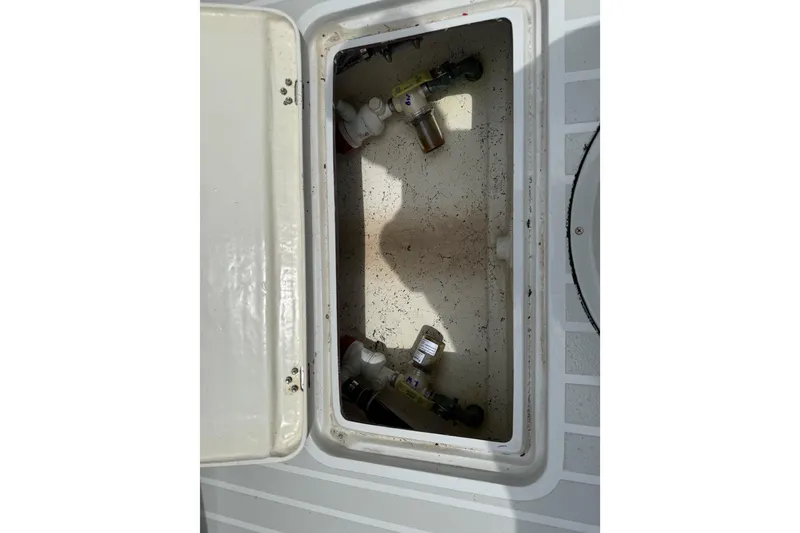 Slide: The Image of Open storage compartment on 2023 Exuma 22 boat, showing interior details. - 12