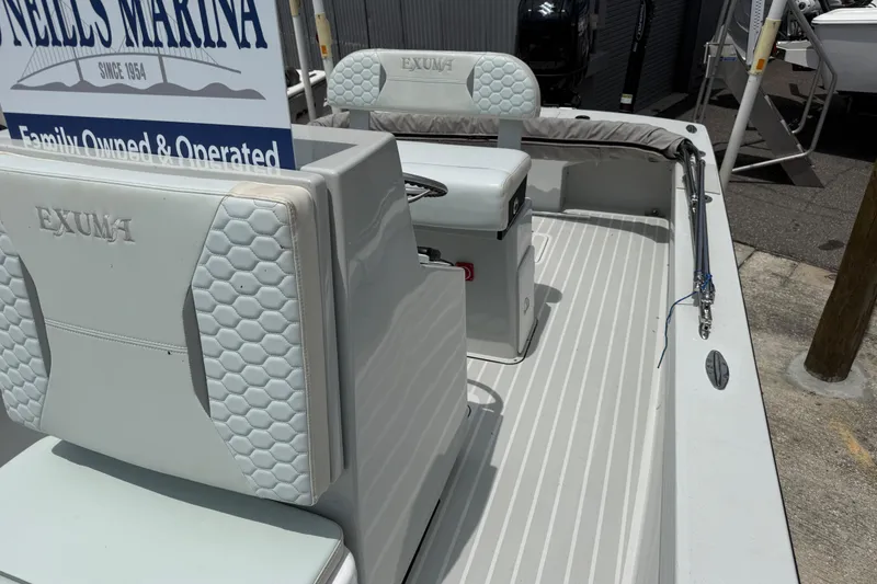 Slide: The Image of 2023 Exuma 22 boat interior with cushioned seating at Neill's Marina. - 8