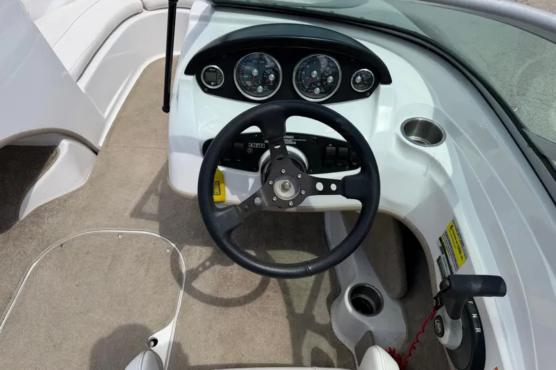 Slide: The Image of 2011 Four Winns H190 boat dashboard with steering wheel and instrument panel. - 11
