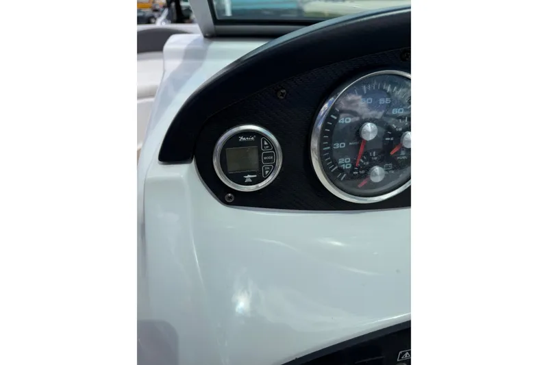 Slide: The Image of Dashboard of a 2011 Four Winns H190 boat with speedometer and controls. - 12