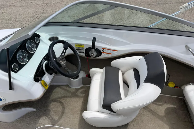 Slide: The Image of Interior of 2011 Four Winns H190 boat showing steering wheel and dashboard controls. - 14