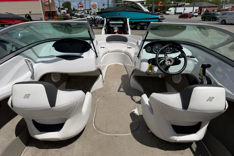 Slide: The Image of Interior view of a 2011 Four Winns H190 boat with white seating and dashboard. - 4