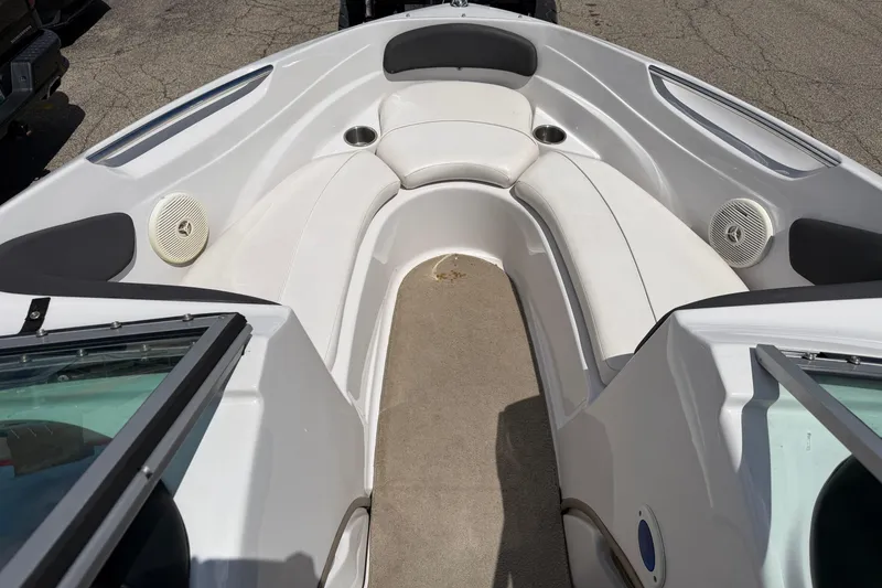 Slide: The Image of 2011 Four Winns H190 boat interior with white seating and speakers. - 8