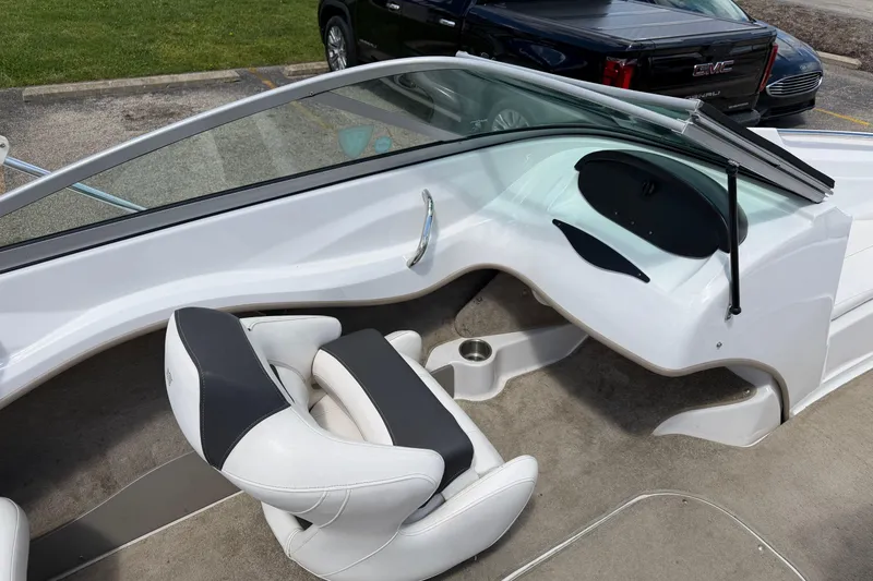 Slide: The Image of Interior of a 2011 Four Winns H190 boat with white seating and dashboard. - 9