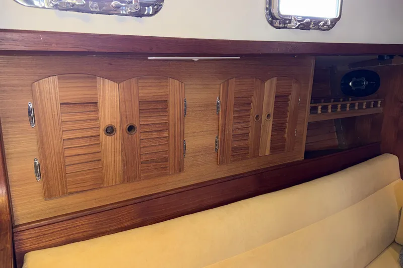 Slide: The Image of Interior of 1983 Valiant Cutter with wooden cabinets and beige seating. - 11