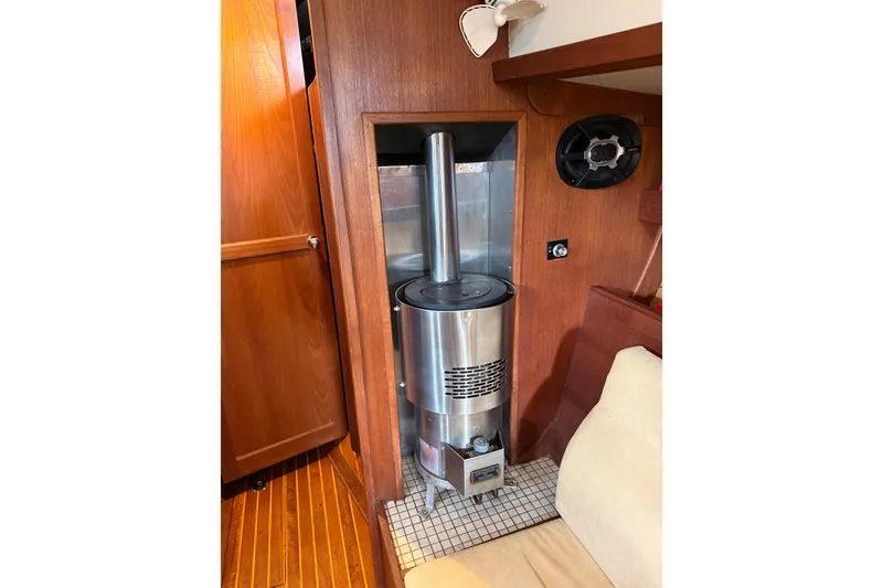 Slide: The Image of Stainless steel heater inside 1983 Valiant Cutter boat with wooden interior. - 12
