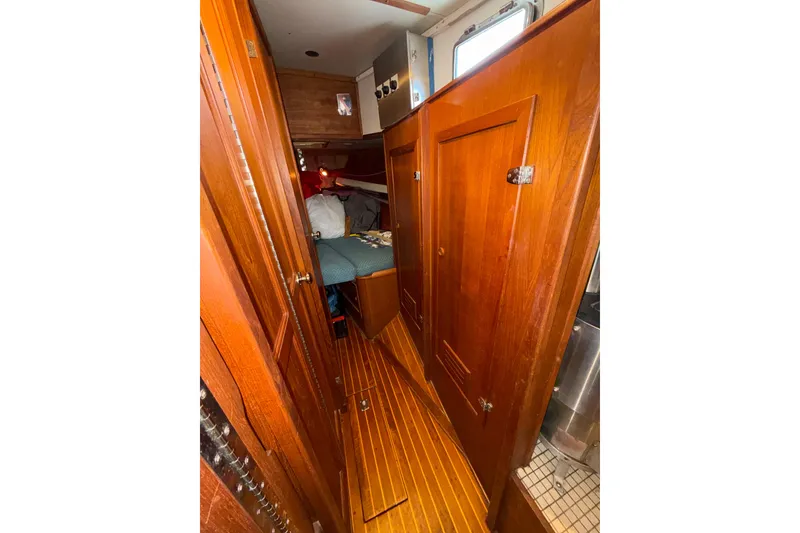 Slide: The Image of 1983 Valiant Cutter interior with wooden cabinetry and cozy sleeping area. - 14
