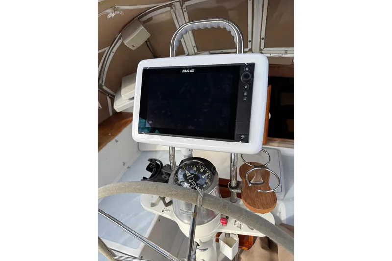 Slide: The Image of Steering wheel and navigation system on a 1983 Valiant Cutter sailboat. - 25