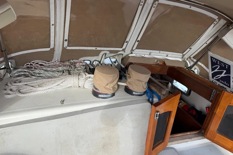 Slide: The Image of Interior of 1983 Valiant Cutter yacht with ropes, winches, and open wooden hatch. - 29