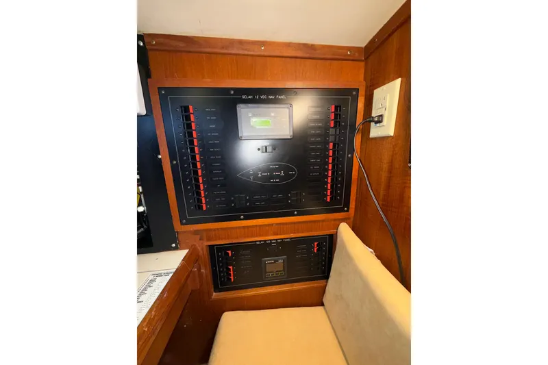 Slide: The Image of Electrical panel inside a 1983 Valiant Cutter boat, featuring switches and controls. - 8