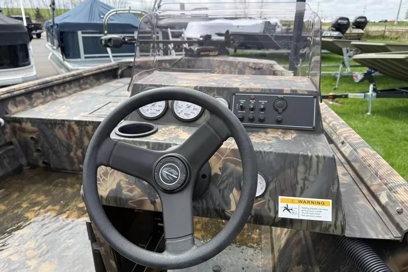 Slide: The Image of 2021 Crestliner 1760 Retriever SC boat dashboard with steering wheel and controls. - 11