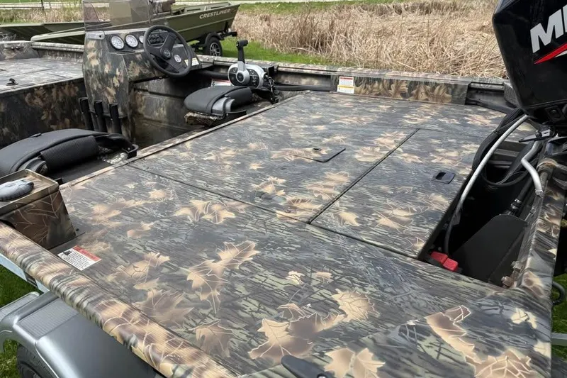 Slide: The Image of 2021 Crestliner 1760 Retriever SC boat with camouflage design and steering console. - 13