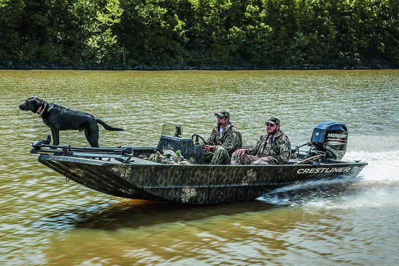 Slide: The Image of Manufacturer Provided Image: 2021 Crestliner 1760 Retriever SC boat with two men and a dog on a lake. - 17