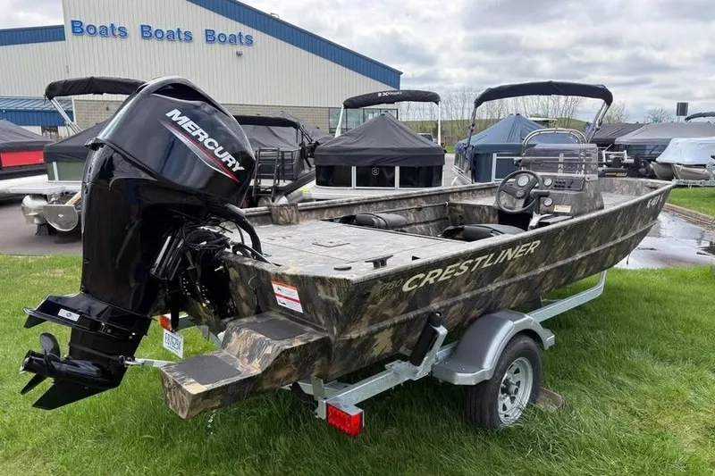 Slide: The Image of 2021 Crestliner 1760 Retriever SC boat with Mercury engine on trailer, parked outdoors. - 3