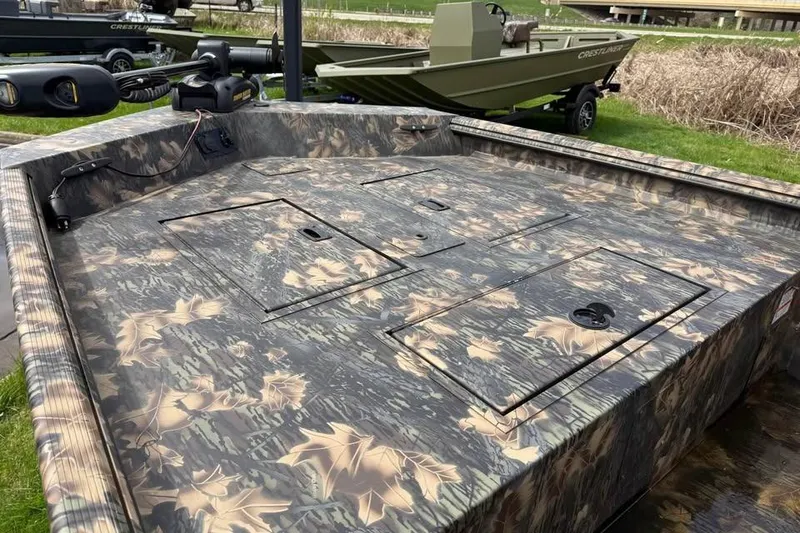 Slide: The Image of 2021 Crestliner 1760 Retriever SC boat with camouflage design, featuring storage compartments. - 8