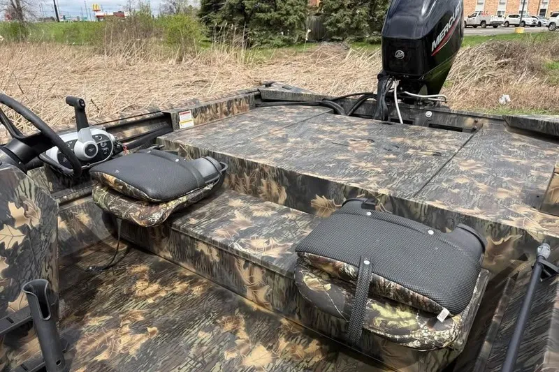 Slide: The Image of 2021 Crestliner 1760 Retriever SC boat with camouflage design and Mercury outboard motor. - 9