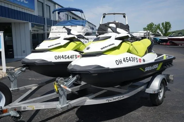 The Image of 2017 Sea-Doo GTI jet skis on trailer, parked outdoors at dealership. - 0