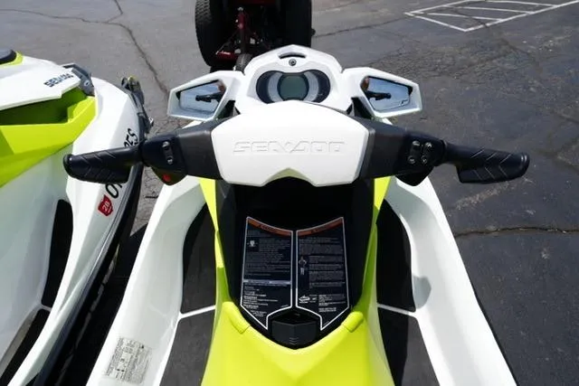 Slide: The Image of 2017 Sea-Doo GTI jet ski handlebars and dashboard, parked on pavement. - 11