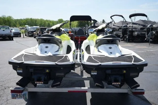 Slide: The Image of Two 2017 Sea-Doo GTI jet skis on a trailer in a parking lot. - 5