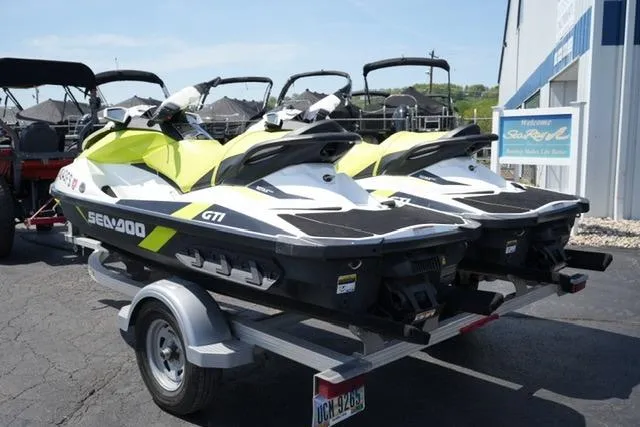 Slide: The Image of 2017 Sea-Doo GTI jet skis on a trailer, parked outside a dealership. - 6