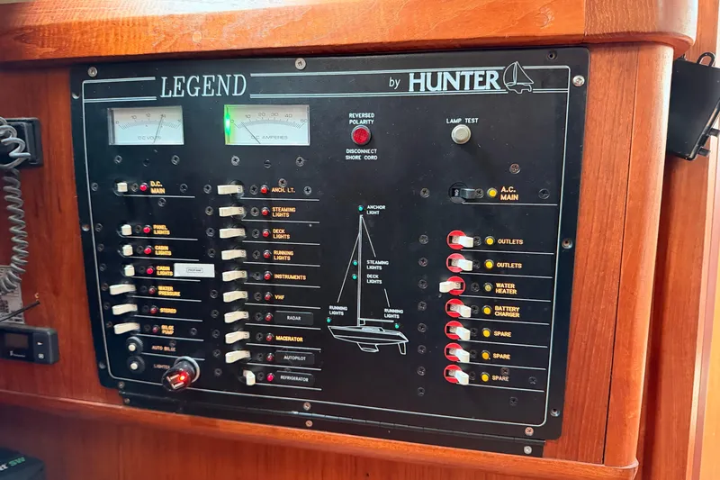 Slide: The Image of Electrical control panel of a 1990 Hunter 37.5 sailboat, featuring various switches and gauges. - 10