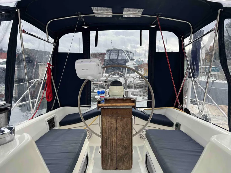 Slide: The Image of Interior view of 1990 Hunter 37.5 sailboat cockpit with steering wheel and seating. - 11