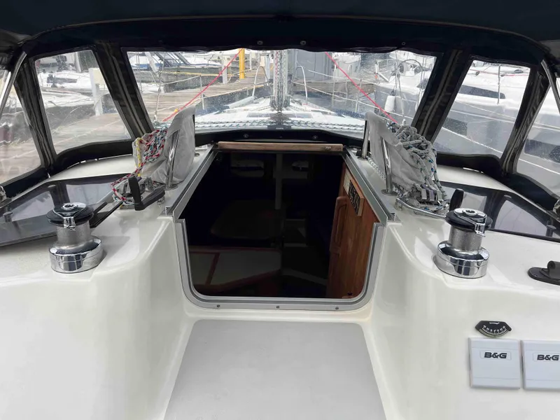 Slide: The Image of 1990 Hunter 37.5 sailboat cockpit with winches and cabin entrance. - 12