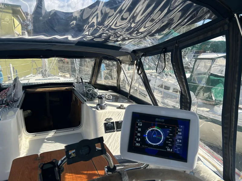 Slide: The Image of Interior view of a 1990 Hunter 37.5 sailboat cockpit with navigation equipment. - 14