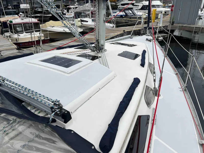 Slide: The Image of 1990 Hunter 37.5 sailboat deck with solar panel, docked in marina. - 15