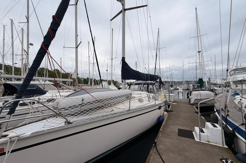Slide: The Image of 1990 Hunter 37.5 sailboat docked at marina, surrounded by other boats. - 18