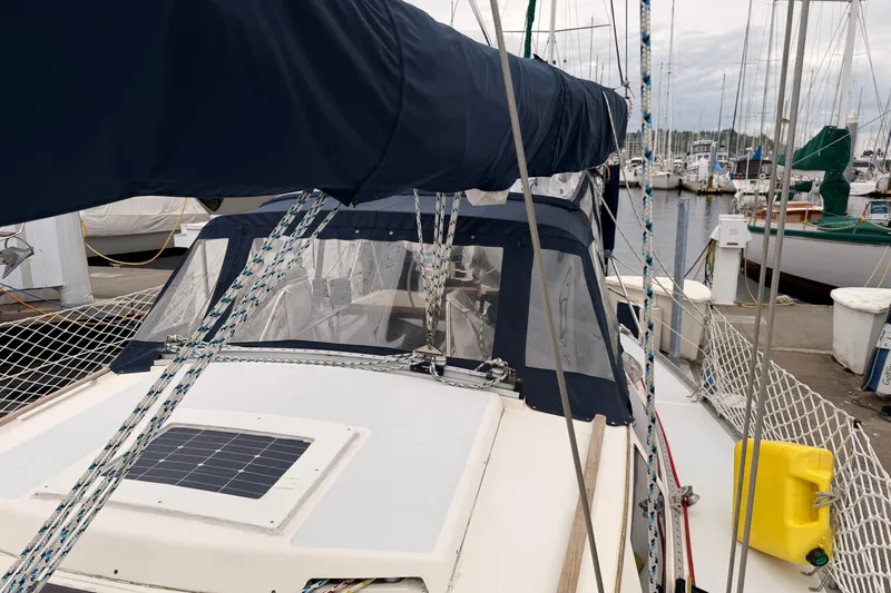 Slide: The Image of Sailboat Hunter 37.5, 1990 model, docked at marina with blue cover and solar panel. - 20