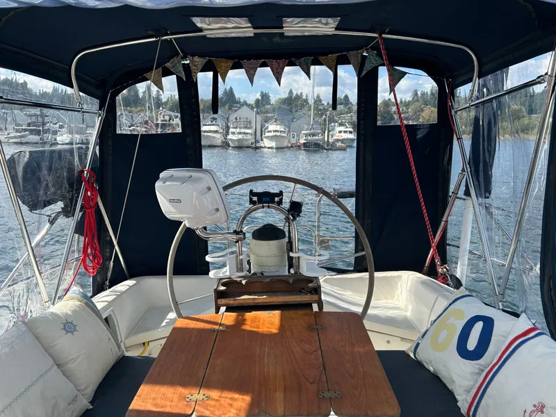 Slide: The Image of Interior view of 1990 Hunter 37.5 sailboat cockpit with marina background. - 21