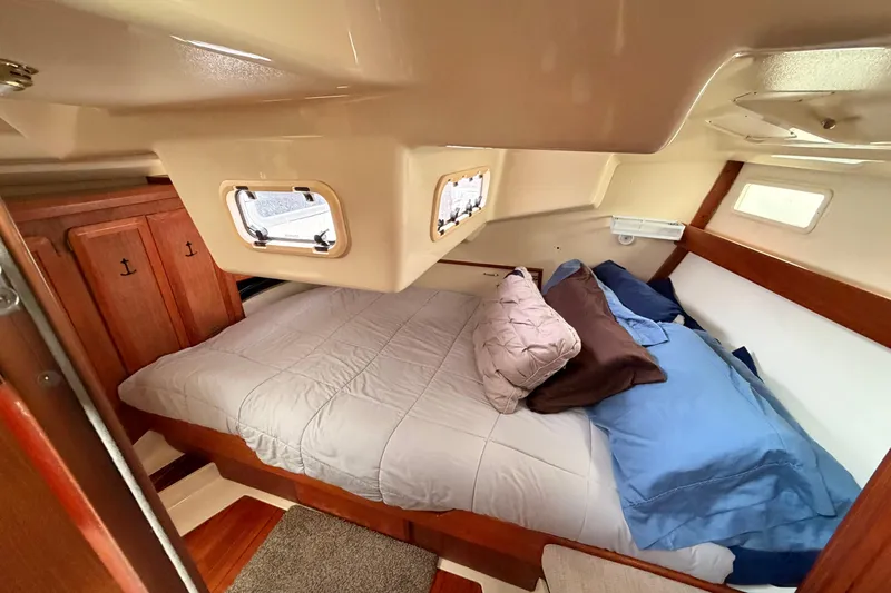 Slide: The Image of Cozy cabin interior of 1990 Hunter 37.5 sailboat with comfortable bedding and wooden accents. - 4