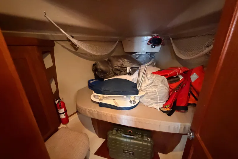 Slide: The Image of Interior cabin of 1990 Hunter 37.5 sailboat with storage items and safety equipment. - 5
