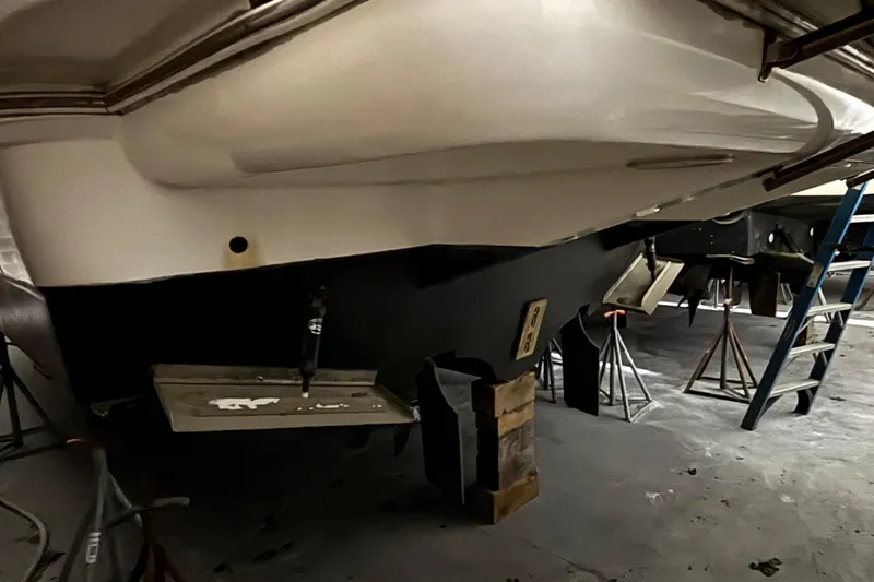 Slide: The Image of 2004 Cruisers Yachts 405 Express Motoryacht in dry dock, showing hull and propeller area. - 13