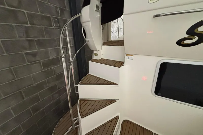 Slide: The Image of Staircase on 2004 Cruisers Yachts 405 Express Motoryacht with teak steps and metal railing. - 16