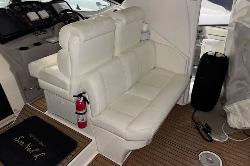 Slide: The Image of 2004 Cruisers Yachts 405 Express Motoryacht interior with white seating and dashboard. - 17