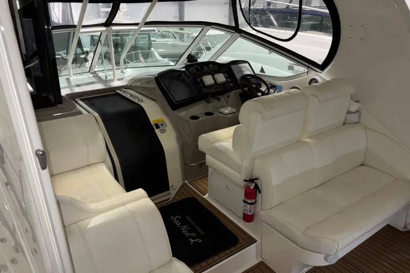 Slide: The Image of 2004 Cruisers Yachts 405 Express Motoryacht cockpit with white seating and control panel. - 18