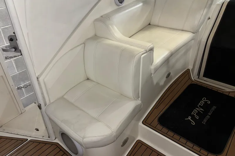 Slide: The Image of 2004 Cruisers Yachts 405 Express Motoryacht interior seating with white upholstery and wooden flooring. - 19