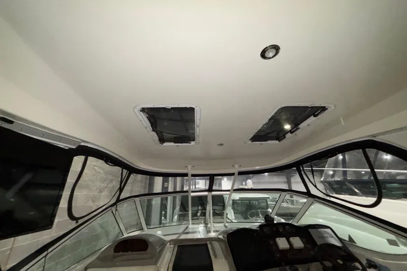 Slide: The Image of Interior view of 2004 Cruisers Yachts 405 Express Motoryacht helm with overhead hatches. - 21
