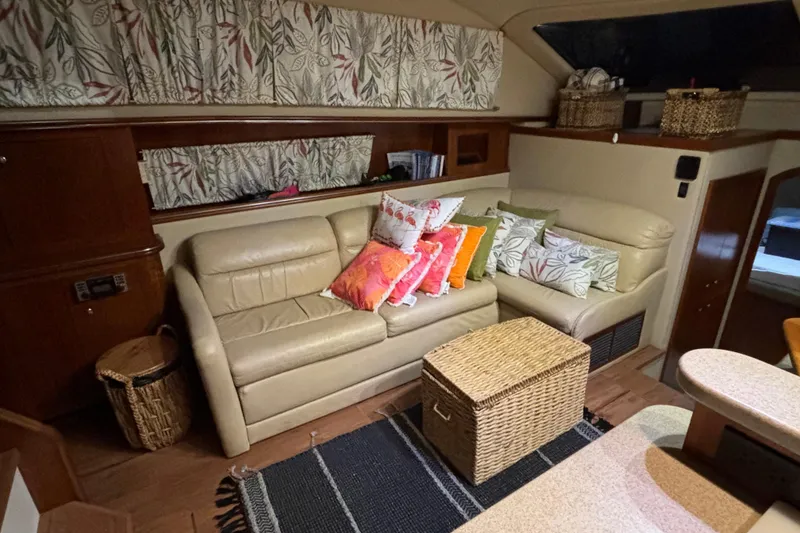 Slide: The Image of Interior of 2004 Cruisers Yachts 405 Express Motoryacht with cozy seating and decorative pillows. - 24