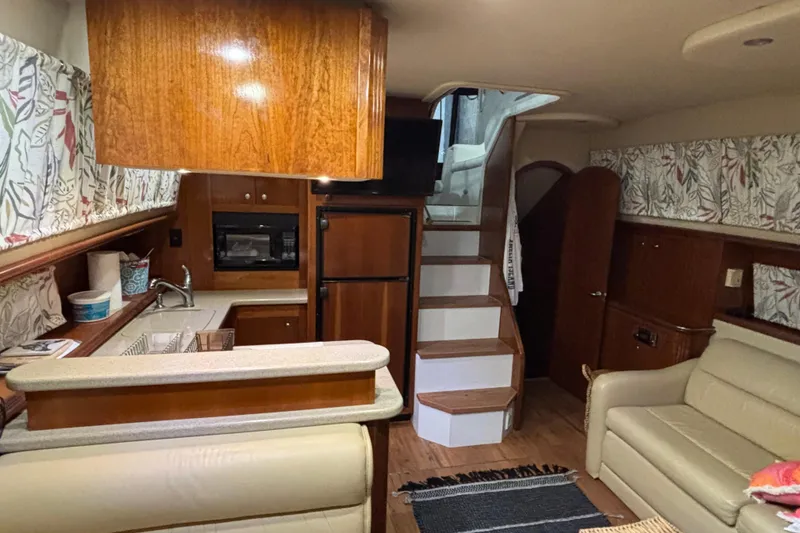 Slide: The Image of Interior of 2004 Cruisers Yachts 405 Express Motoryacht with kitchen and seating area. - 25
