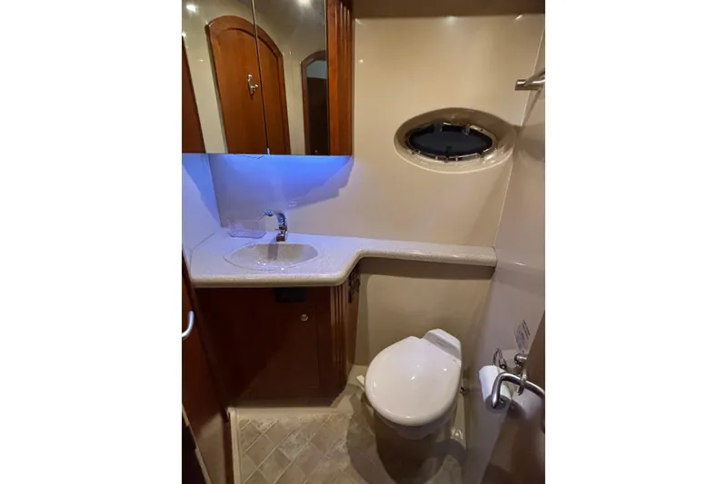 Slide: The Image of Bathroom interior of 2004 Cruisers Yachts 405 Express Motoryacht with sink and porthole window. - 27