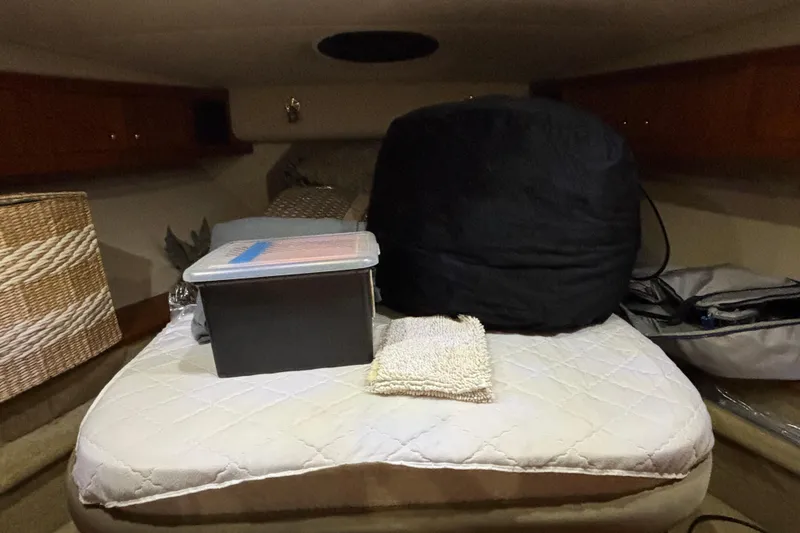 Slide: The Image of 2004 Cruisers Yachts 405 Express Motoryacht interior cabin with storage and bedding. - 29
