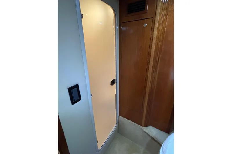 Slide: The Image of 2004 Cruisers Yachts 405 Express Motoryacht interior door and wooden cabinetry. - 31